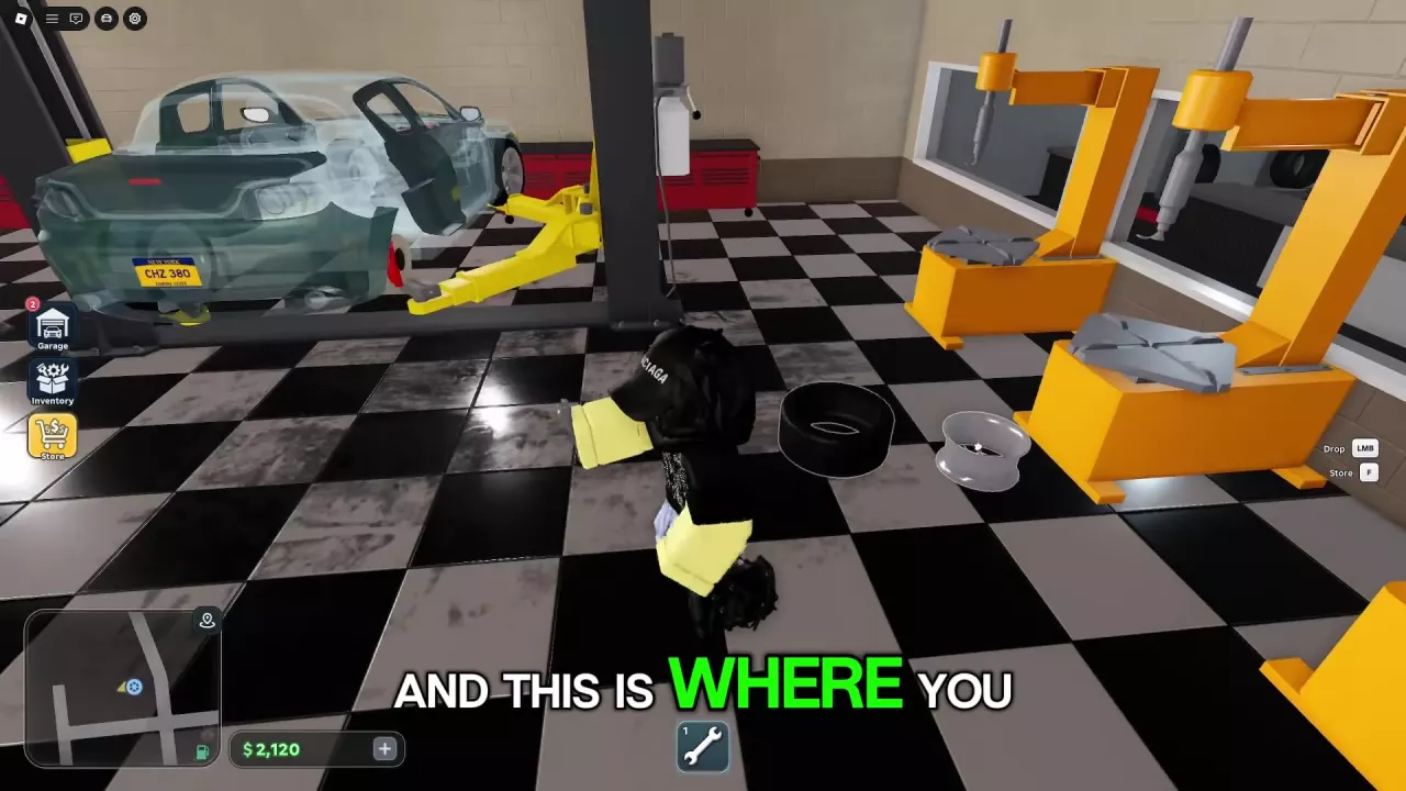 Separated tire and rim beside tire machines and a raised car